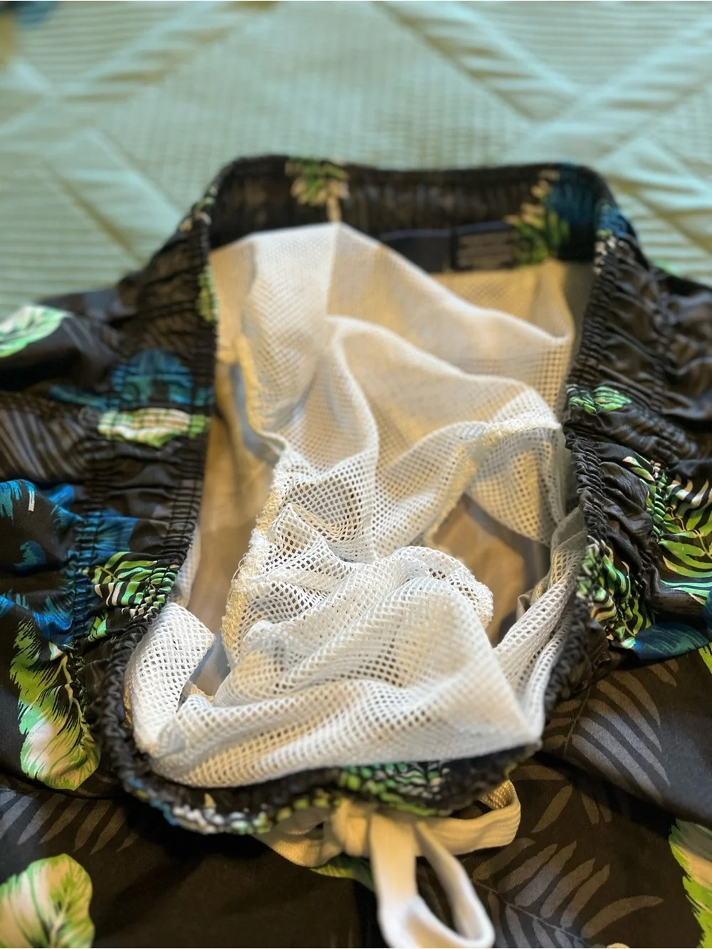 Pair of Kanu Surf Men's Blue Camo & Black Floral Swim Trunks